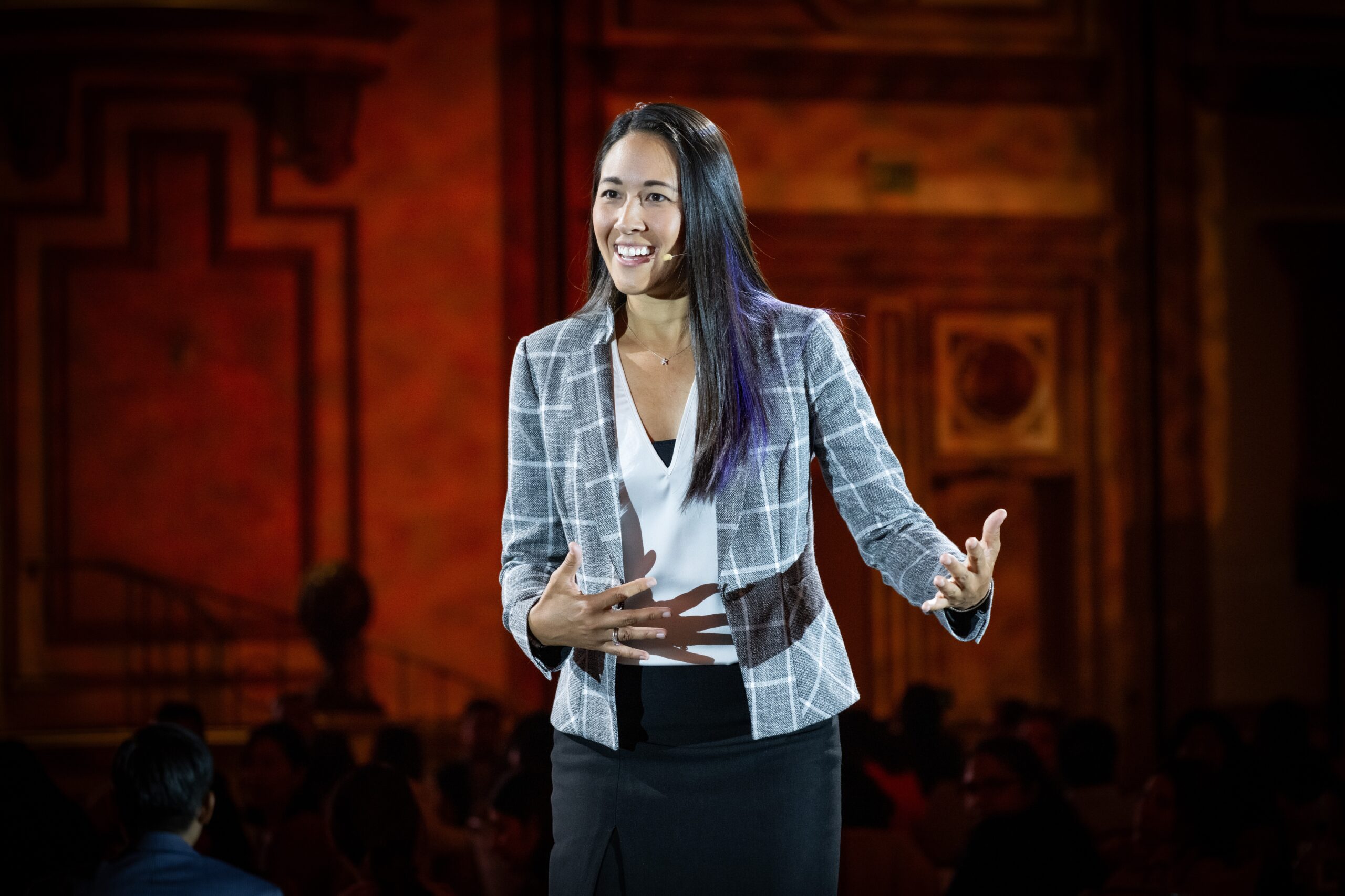 Laura speaking, red background