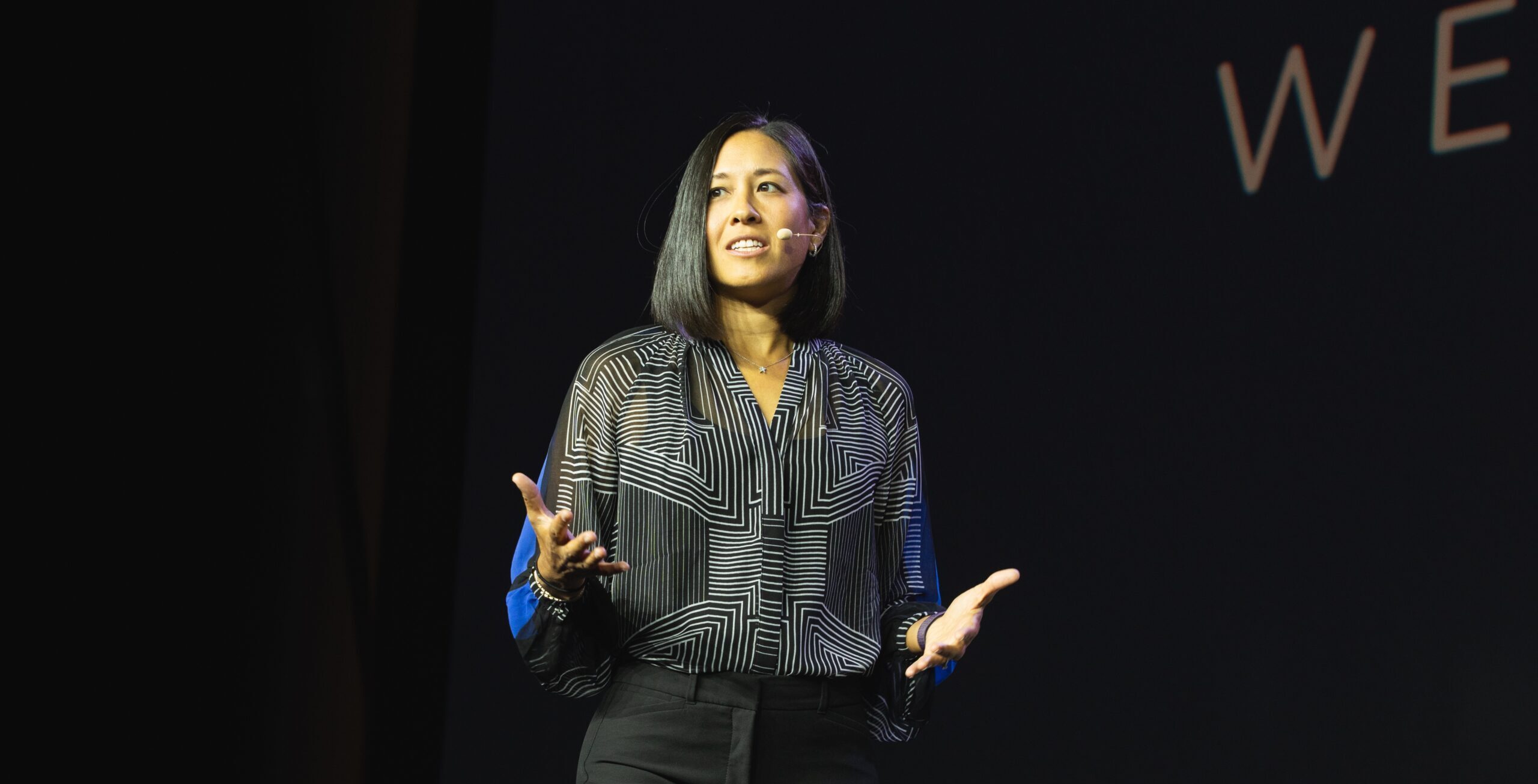 Laura speaking on stage